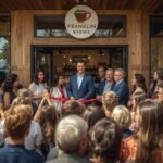 Crowds gather at the ribbon-cutting ceremony for Franklin Brews, a new cafe in Sheffield, Franklin County, featuring local coffee blends and farm-to-table pastries on Main Street.